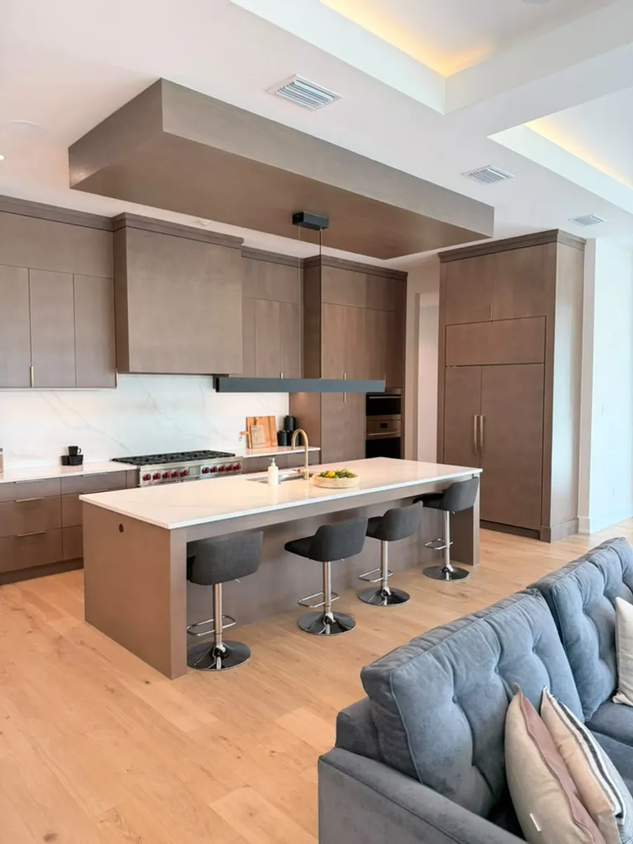 Kitchen island area finished with engineered wood flooring