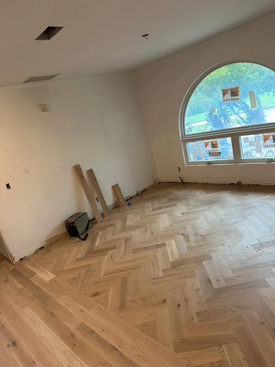 Great room finished with a custom herringbone wood-look floor