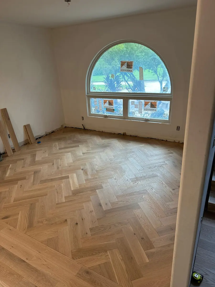 Herringbone flooring being hand-laid, board by board