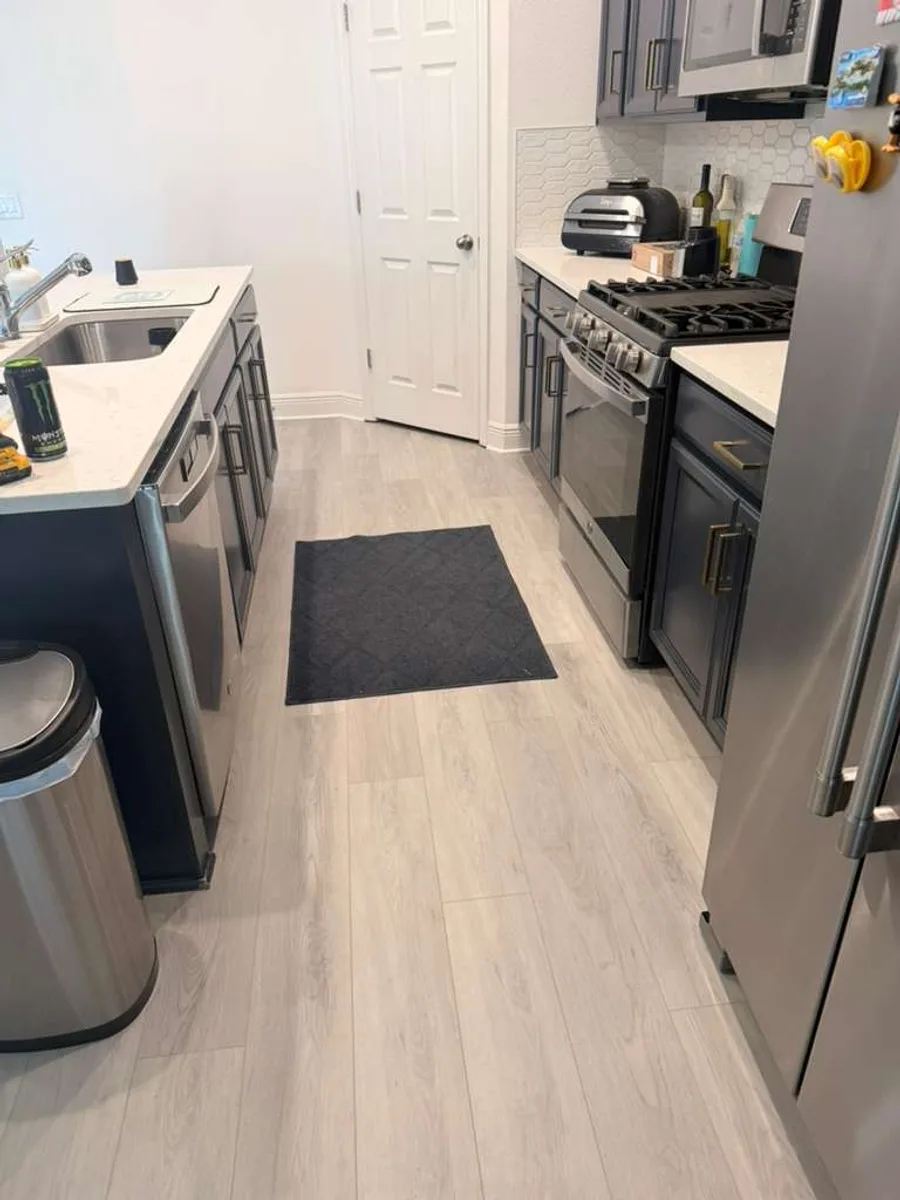 Modern kitchen with new wood-look flooring