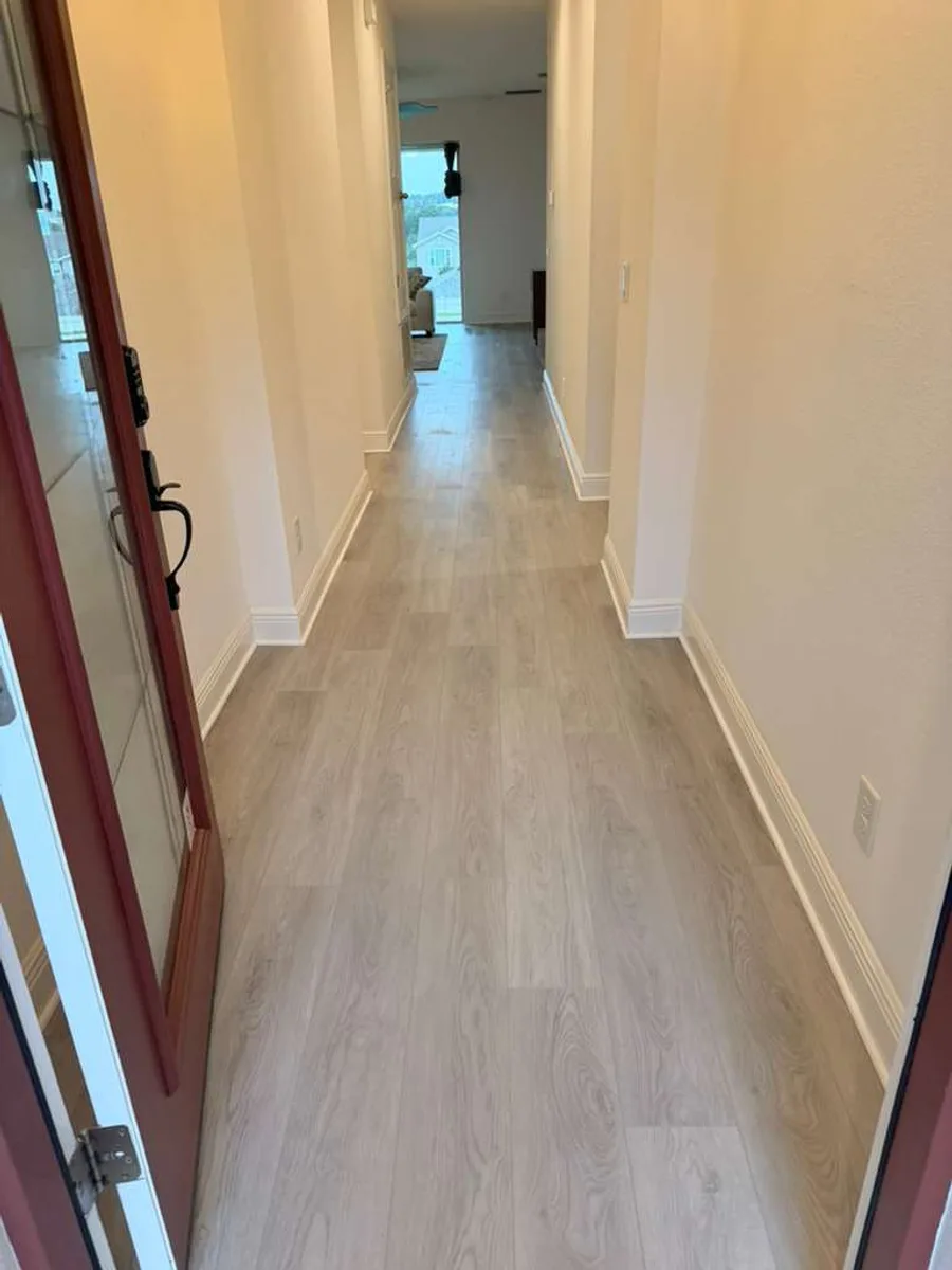 Entry hallway finished with wide plank flooring
