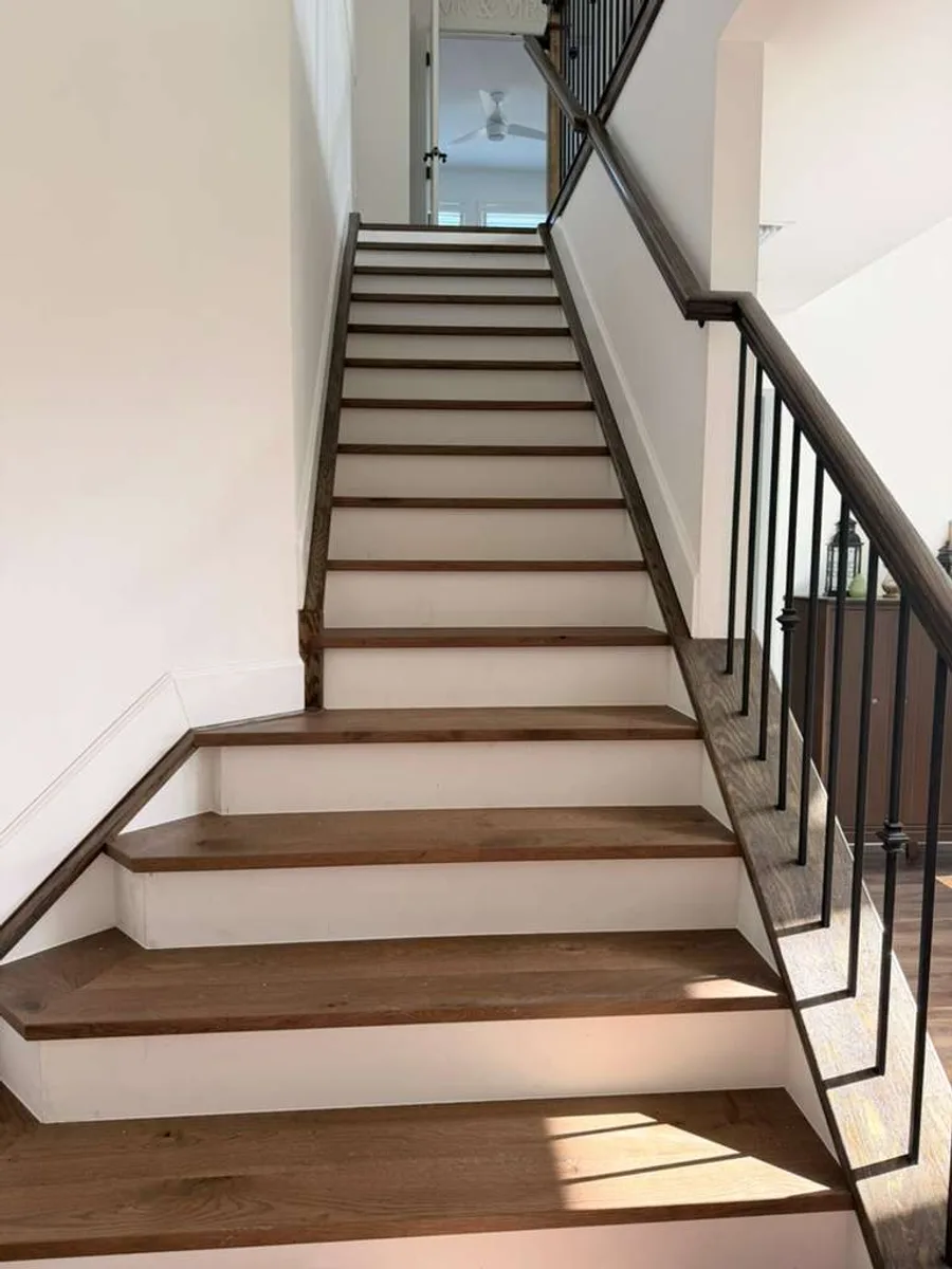 Staircase with custom wood treads and iron railing