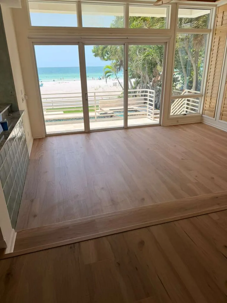 Great room finished with wood-look flooring and an ocean view