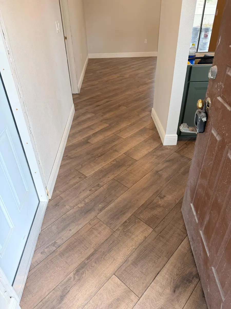 Hallway finished with dark wood-look laminate flooring