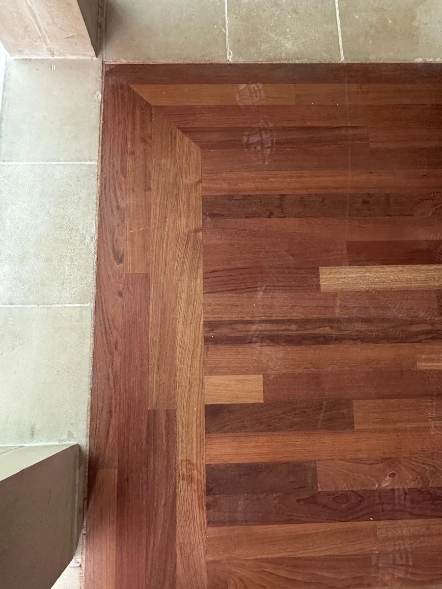 Grand columned great room with freshly sanded and stained hardwood flooring